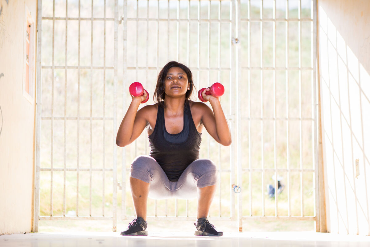 Woman performing dumbbell weighted squats