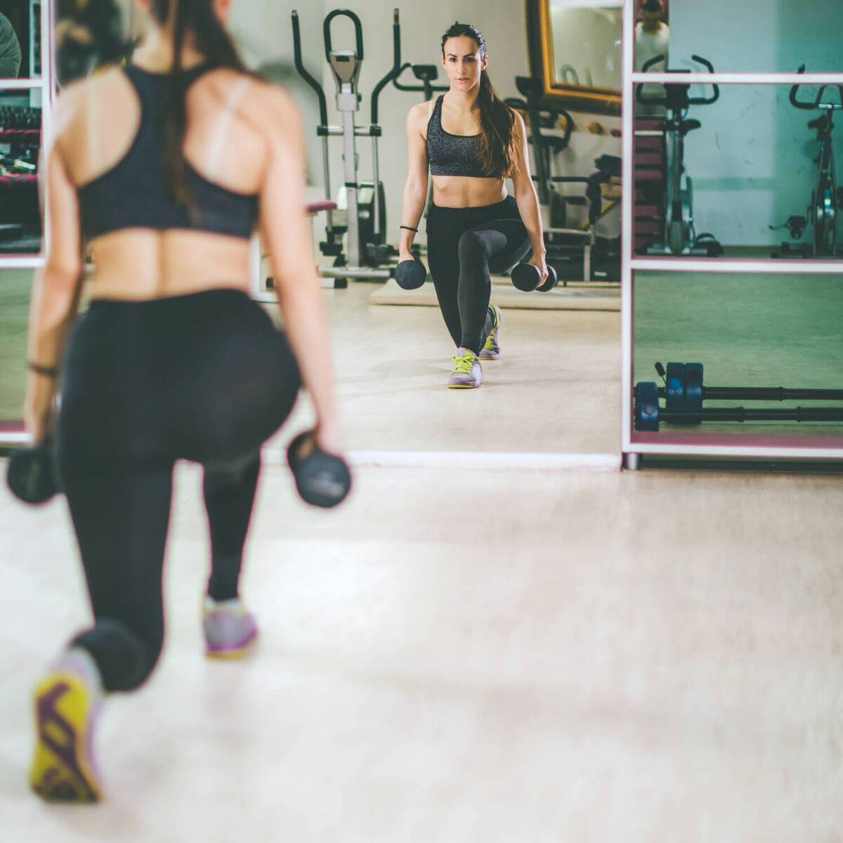 woman working out with dumbbells