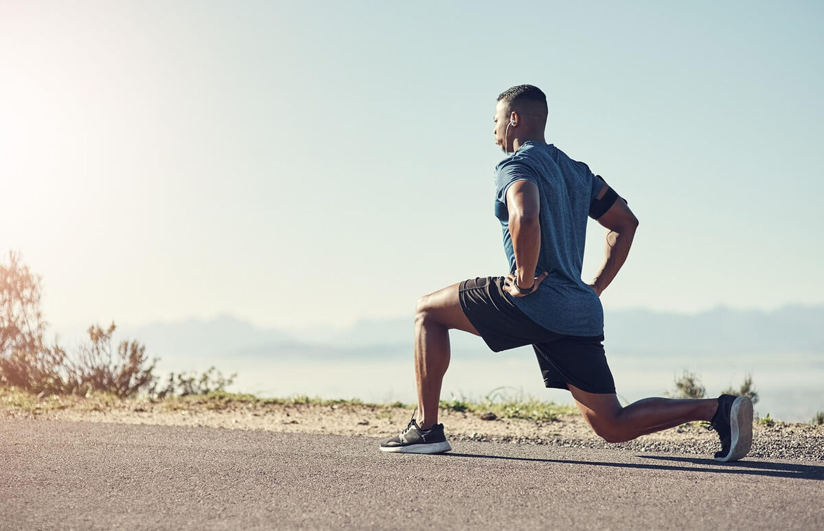 man doing lunges outdoors