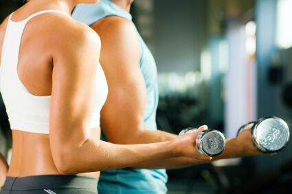 Couple performing biceps curls