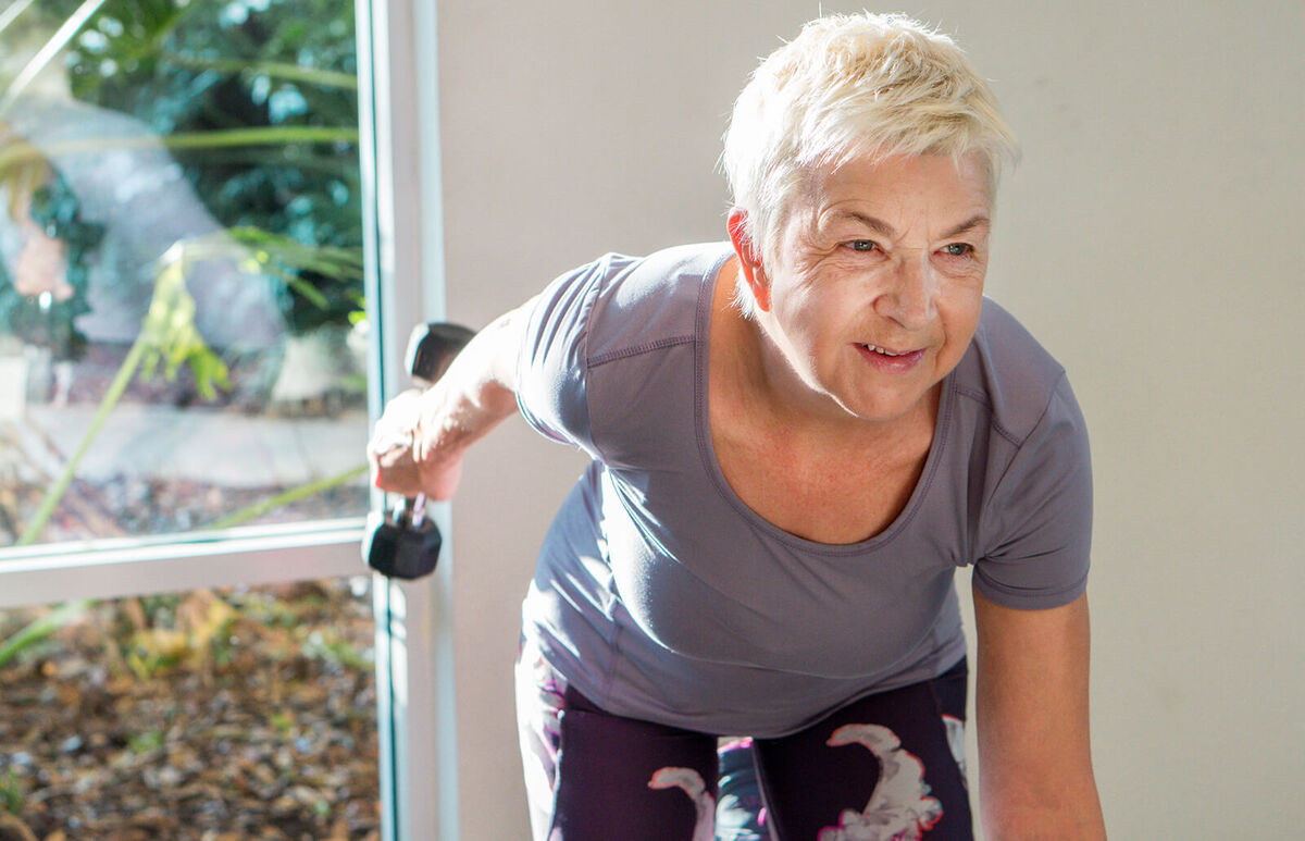 Senior Woman Exercising At Gym