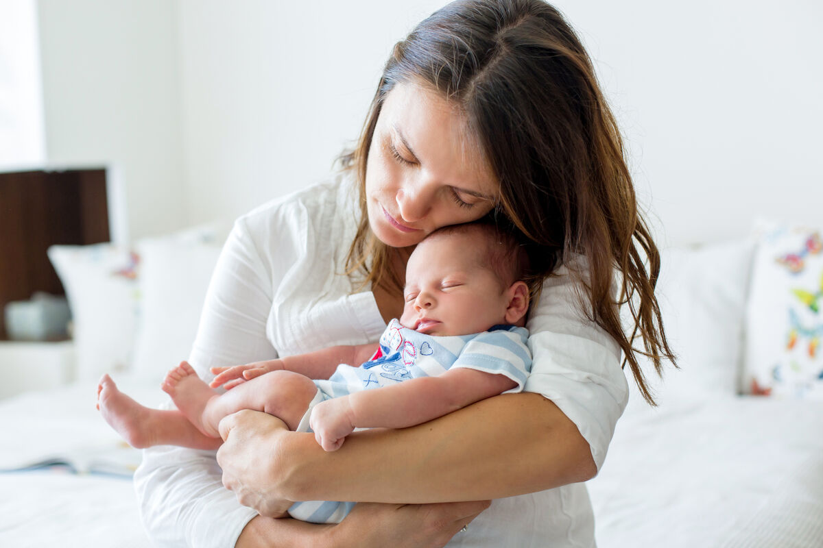 Young mother holding newborn