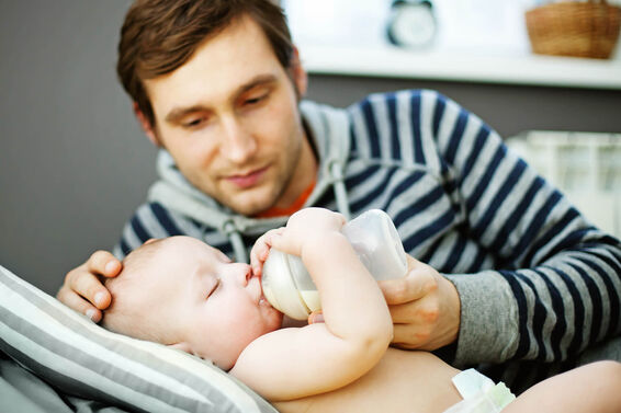 father feeding his baby