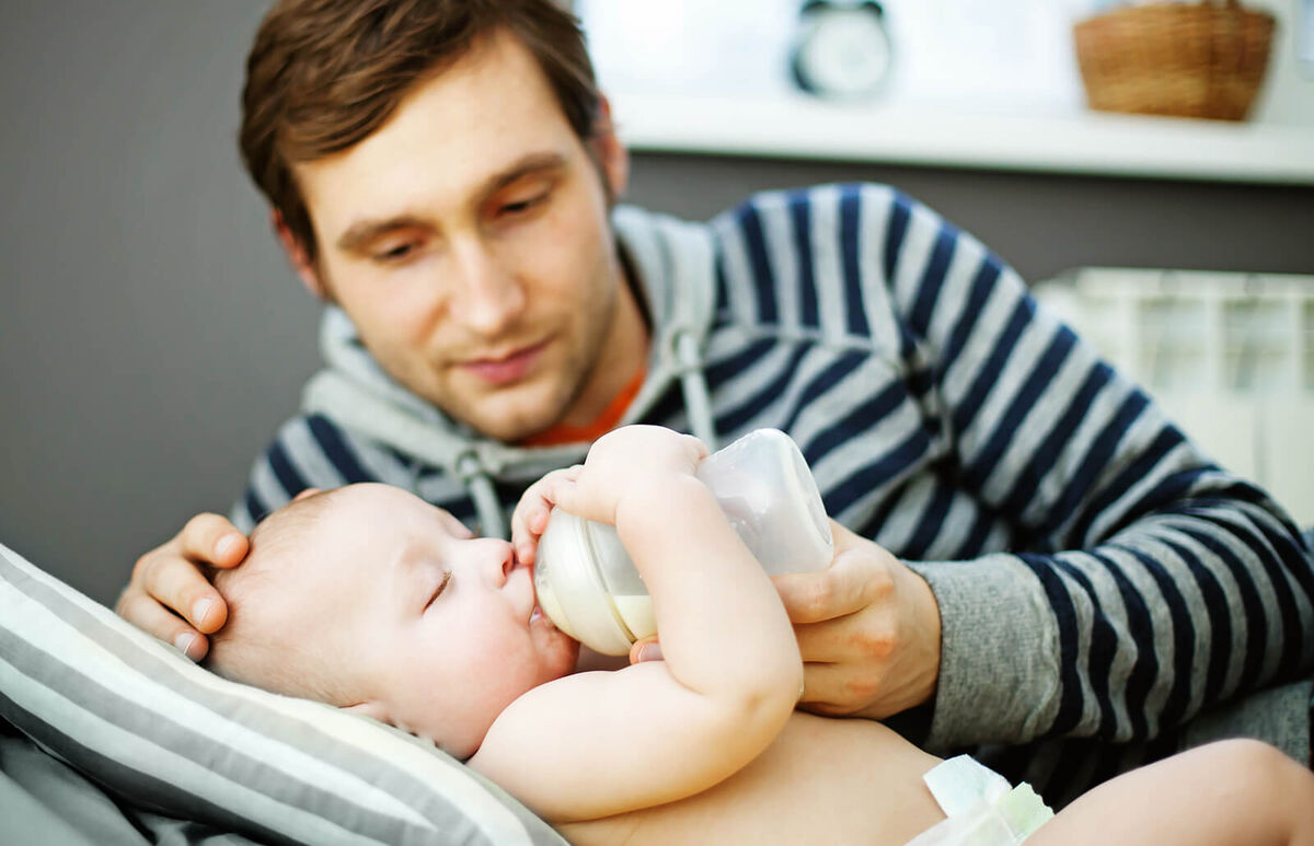father feeding his baby