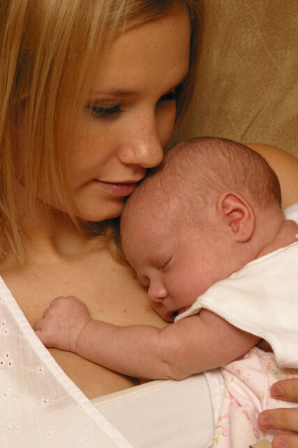 mom holding sleeping infant