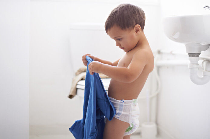 boy dressing in bathroom
