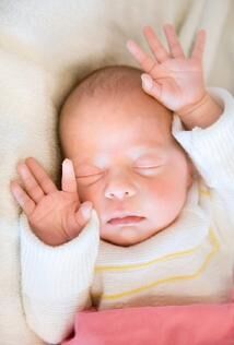 Image of an infant sleeping on his back