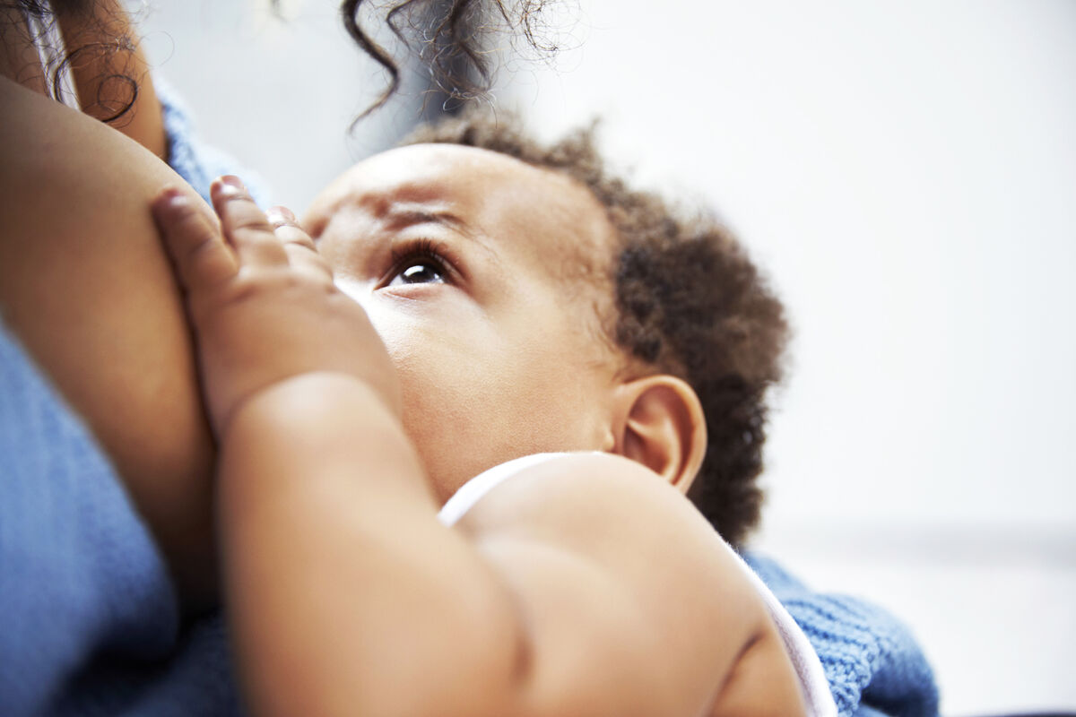 Mother breastfeeding baby boy