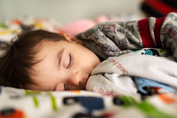 Toddler Sleeping on a Bed Attempting to Recover from the Cold