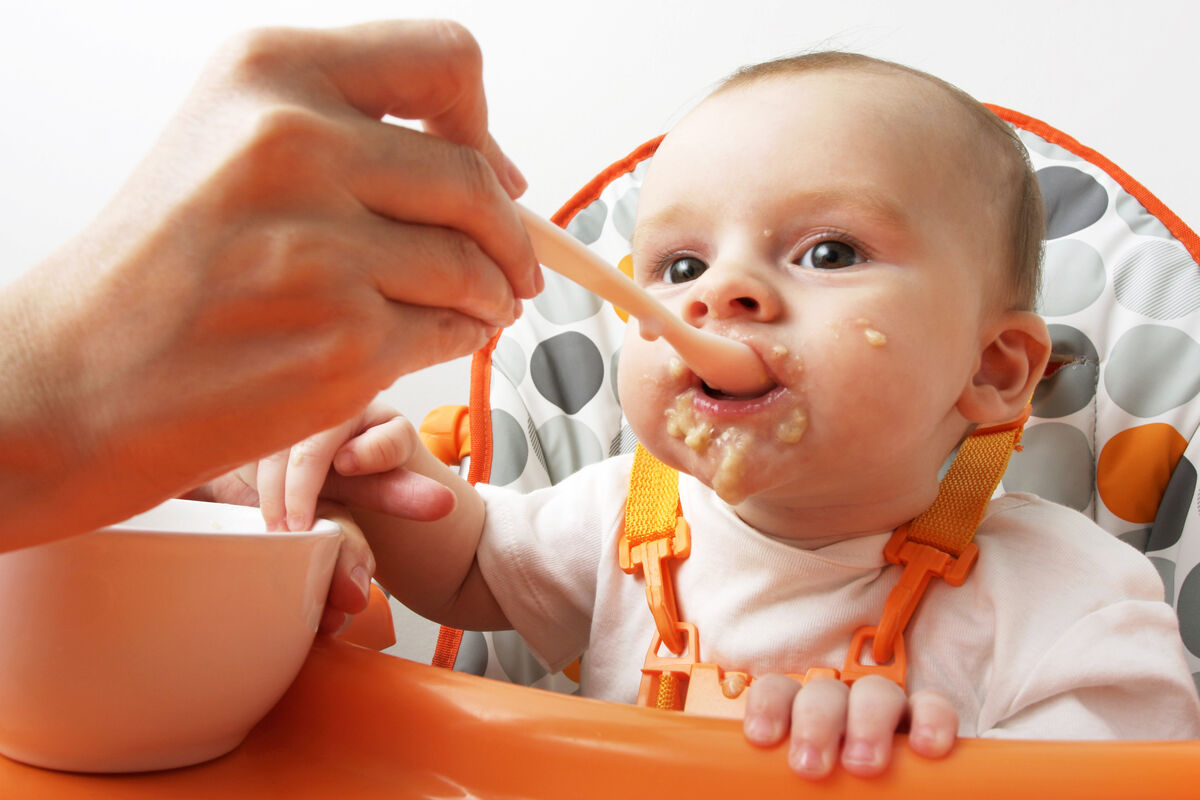 Baby enjoying mashed banana