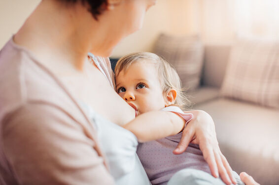 Mother breastfeeding toddler