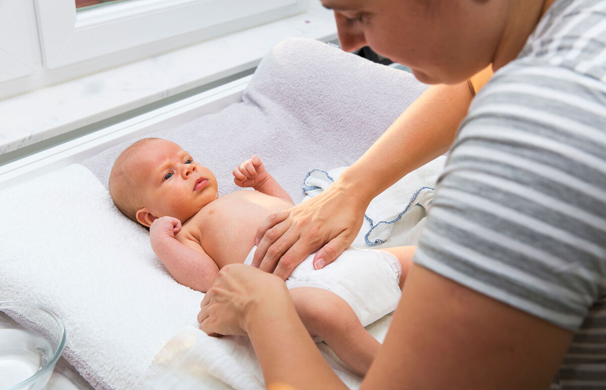 mother changing diapers