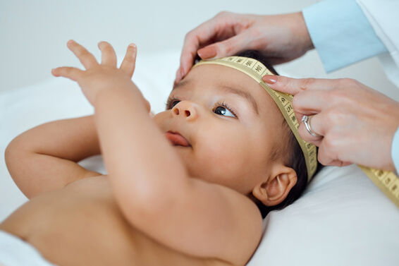 Shot of a paediatrician measuring a baby's head in a clinic