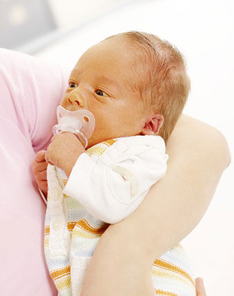 Mother holding newborn jaundice baby
