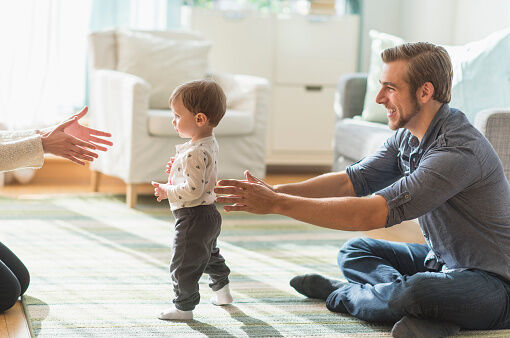 parents helping little son