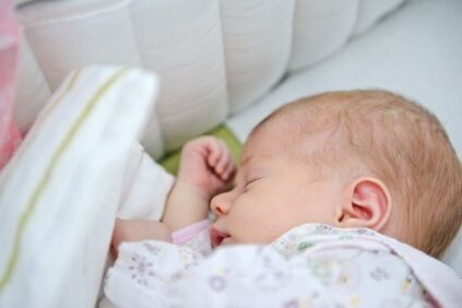 Infant sleeping on her side