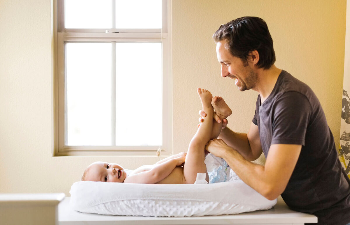 Father changing sons diaper