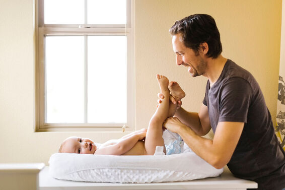 Father changing sons diaper