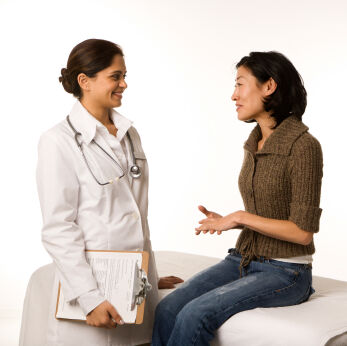 Young woman talking with her doctor