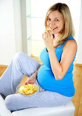 Pregnant woman eats chips