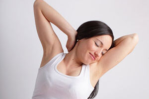 Pregnant woman stretching in bed