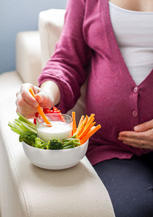 Pregnant woman having healthy snack
