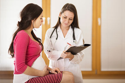 Pregnant woman with doctor
