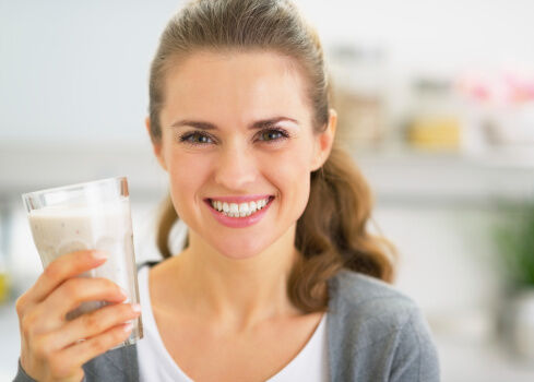 Pregnant woman holding a protein shake