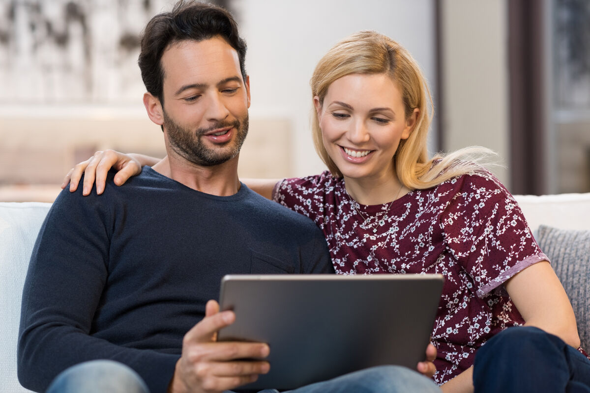 Couple looking at digital tablet
