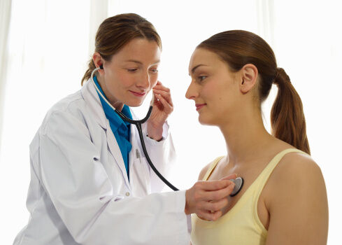 doctor using stethoscope on patient