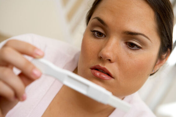 Woman checking pregnancy test