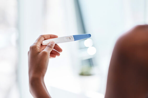 Woman taking a pregnancy test at home