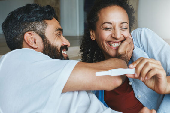 Shot of a happy couple celebrating their new pregnancy at home together