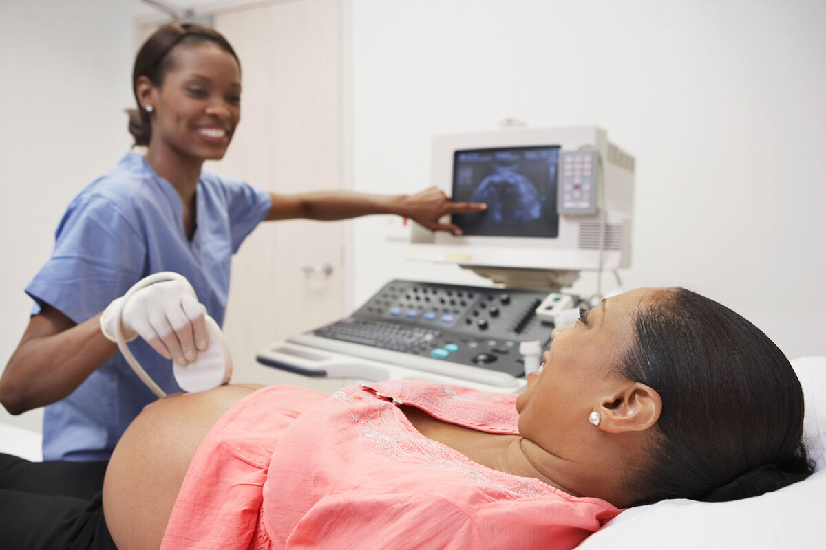 Pregnant African woman having ultrasound