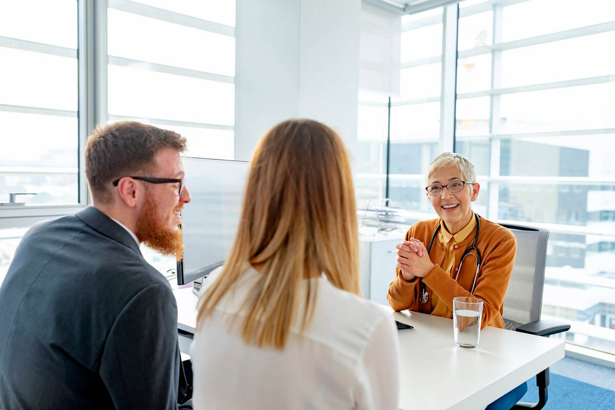 Young couple on consultation with doctor at the clinic