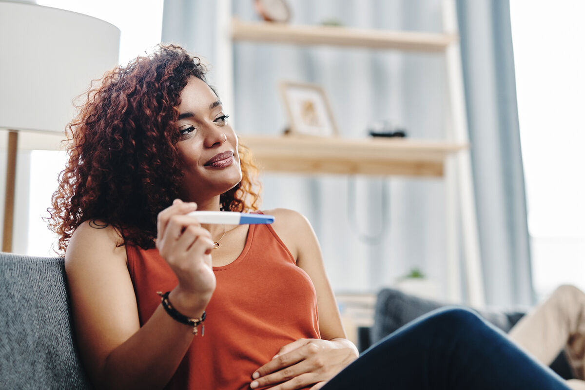 young woman holding a ovulation test at home