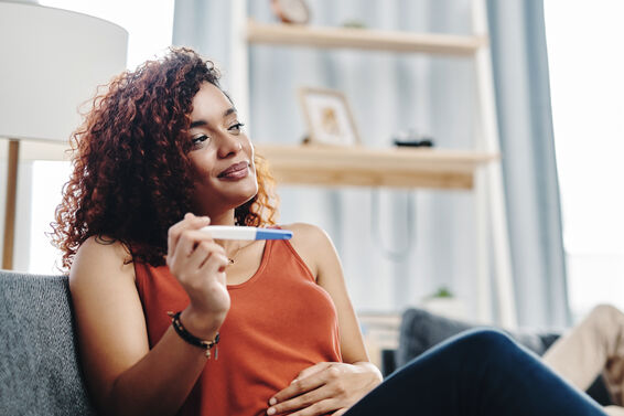 young woman holding a ovulation test at home