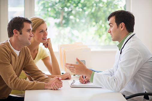 Couple receiving advice from doctor
