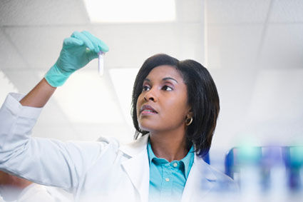 Lab technician examining test tube