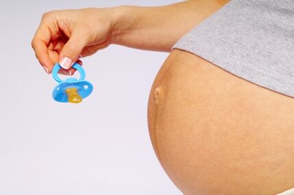 very pregnant woman enticing baby out