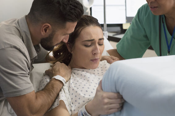 Woman in labor with partner coaching