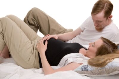 Husband coaching wife in Lamaze breathing