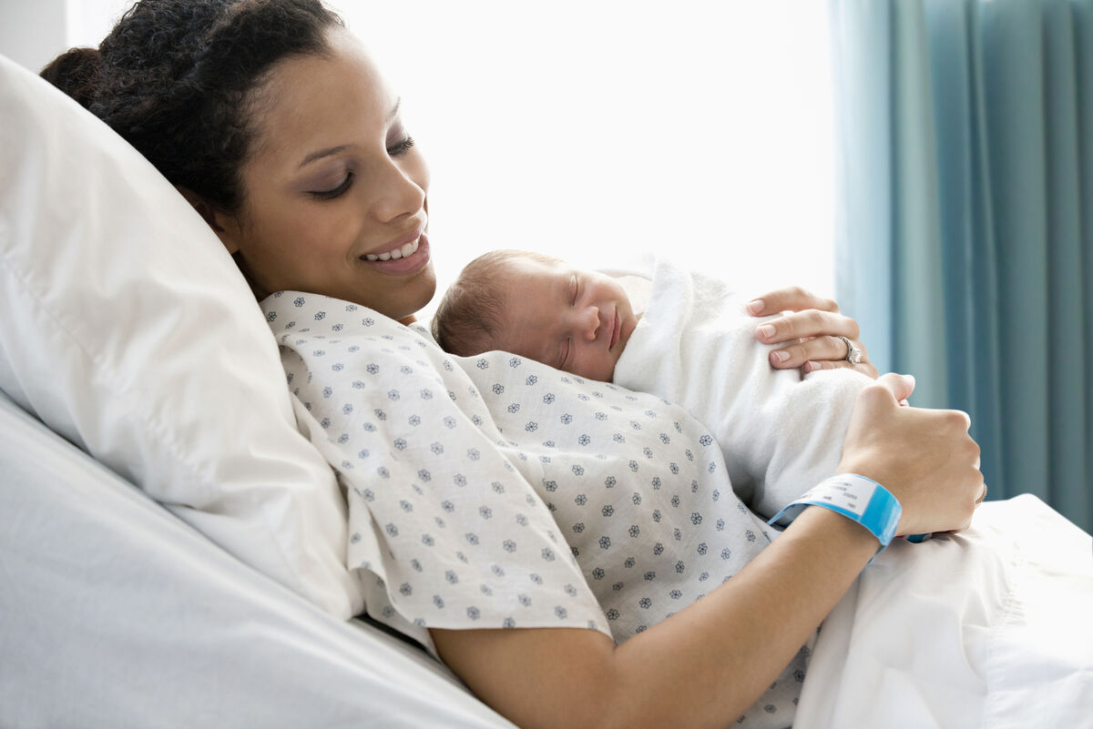 Mother admiring newborn baby son