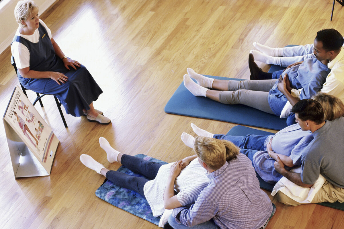 Husbands and their pregnant wives at a prenatal class