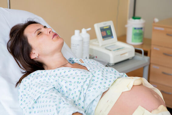 Woman having back pain during a contraction