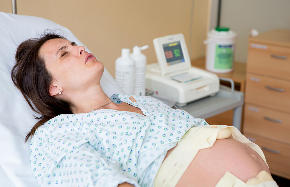 Woman having back pain during a contraction