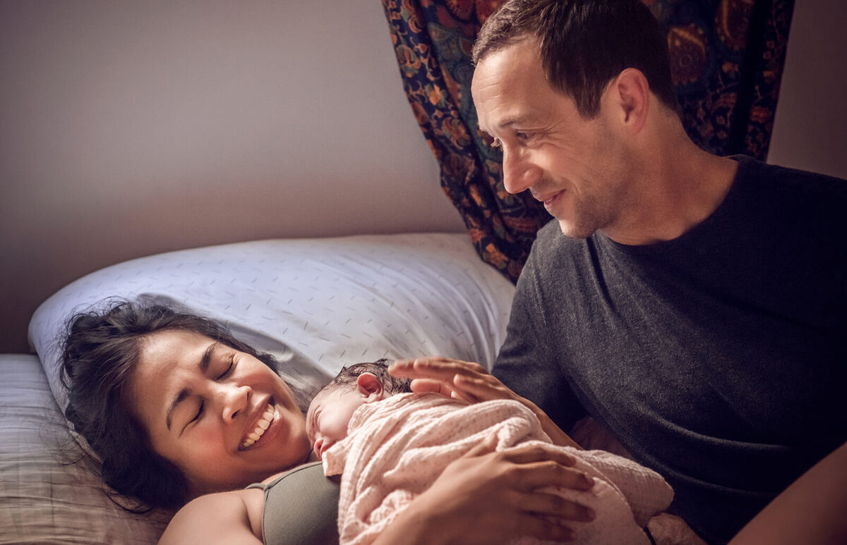 Smiling Parents With Newborn