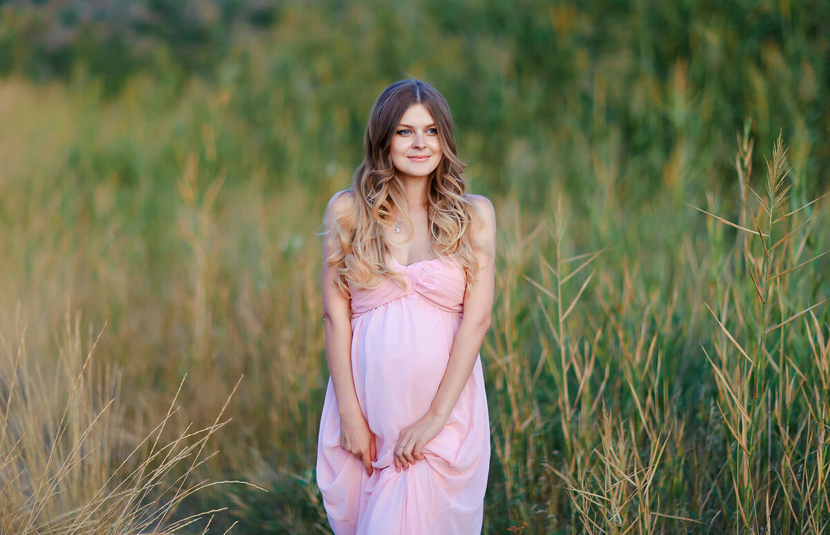 Pregnant woman hugging belly