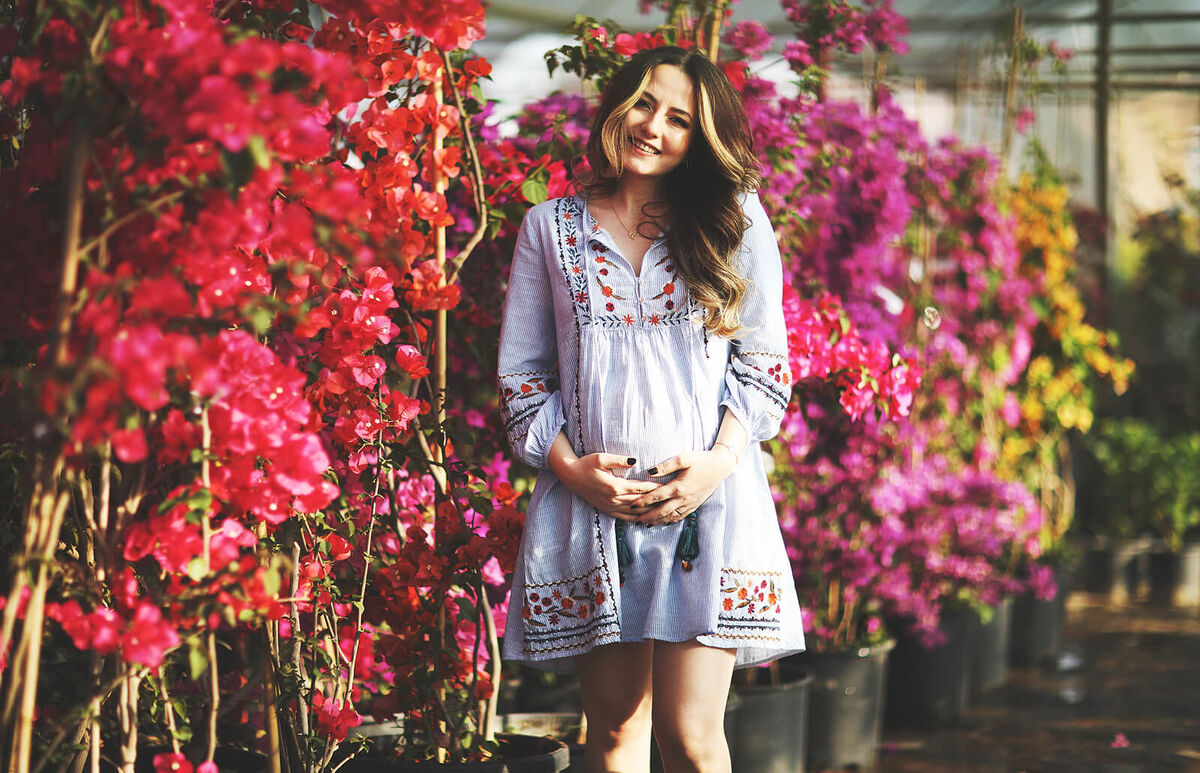 pregnant woman on flower garden