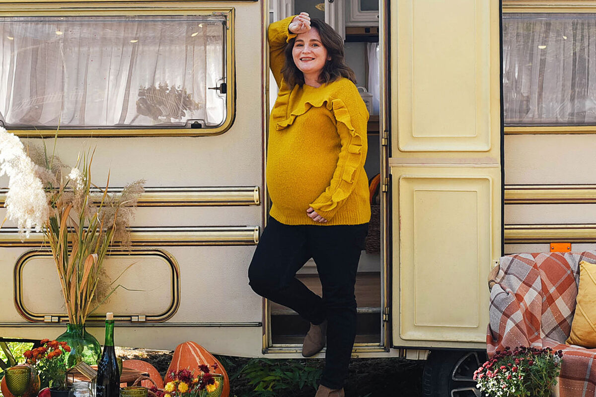 pregnant person wearing sweater